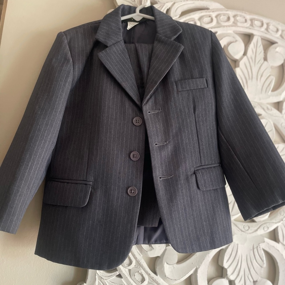 Gray suit with white pen strip.